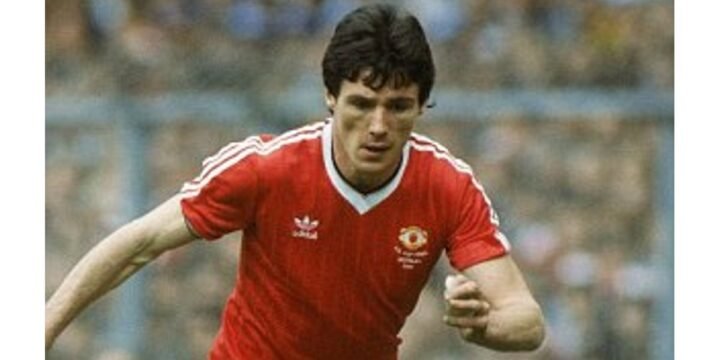 Frank Stapleton playing on the pitch for Manchester United in the red jersey