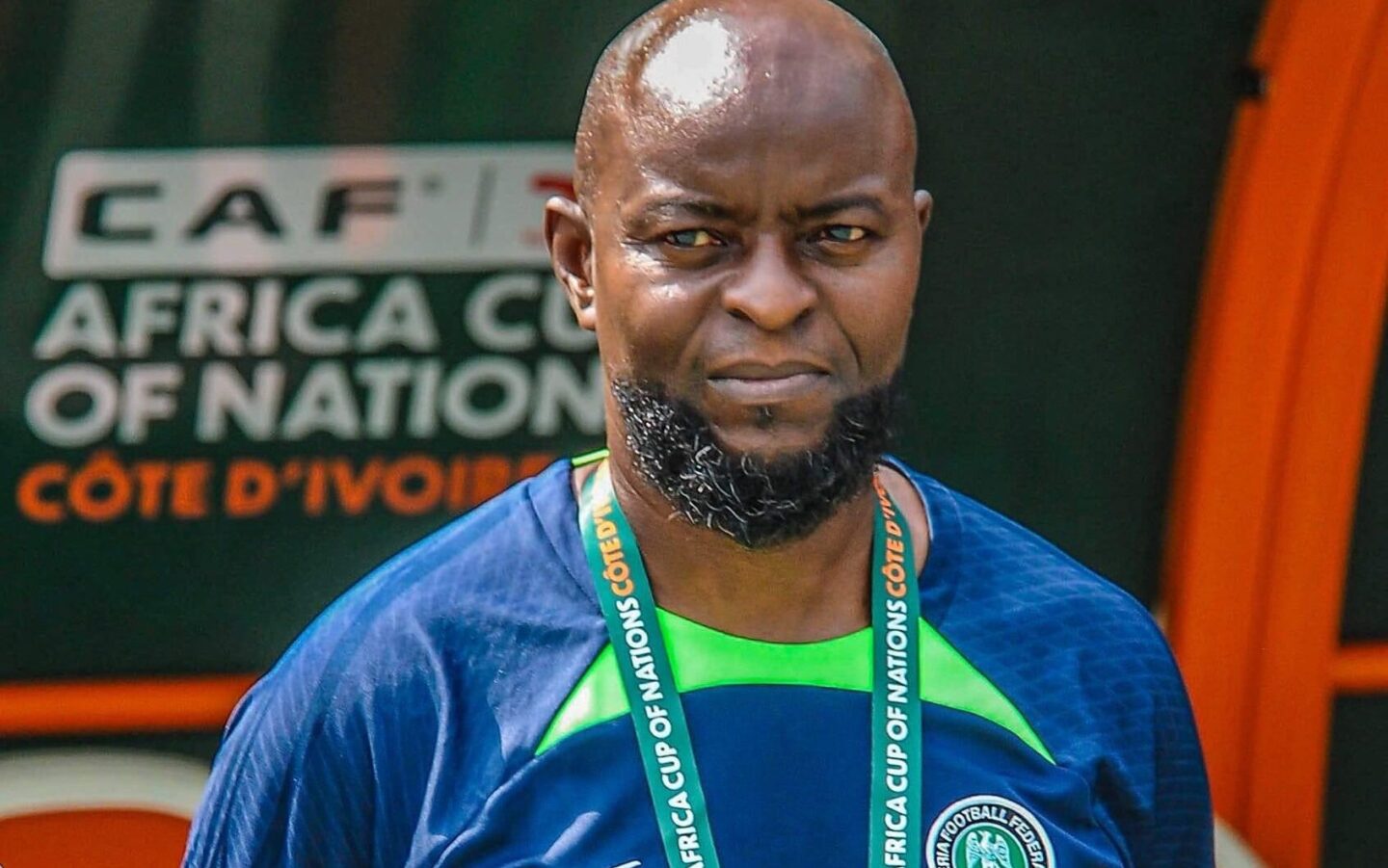 Finidi George in a dark blue tracksuit wear for Nigeria at the AFCON 2023 tournament