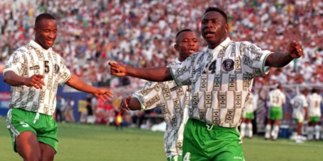 Daniel Amokachi celebrating his gaol for Nigeria as a player on the pitch
