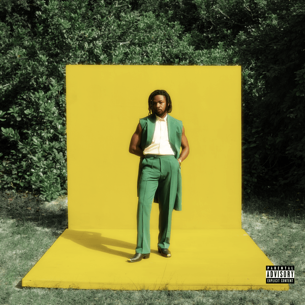 Johnny Drille is wearing a green colour pant suit and a white shirt as the cover art for his new single Palava
