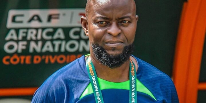 Finidi George in a dark blue tracksuit wear for Nigeria at the AFCON 2023 tournament